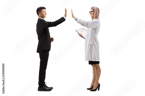 Young guy in a suit and a female doctor gesturing high-five