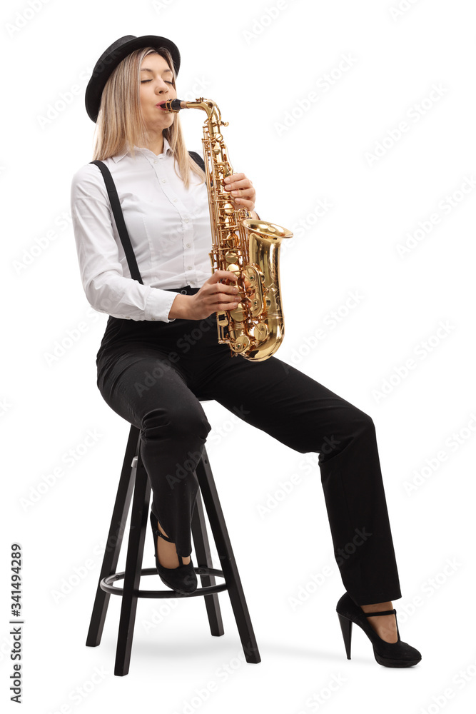 Naklejka premium Young blond female artist playing a saxophone