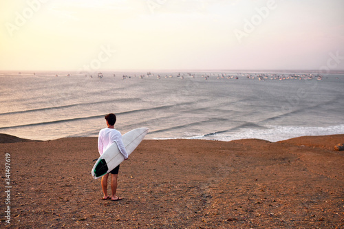 A surfer overlooks the empty waves at Chicama