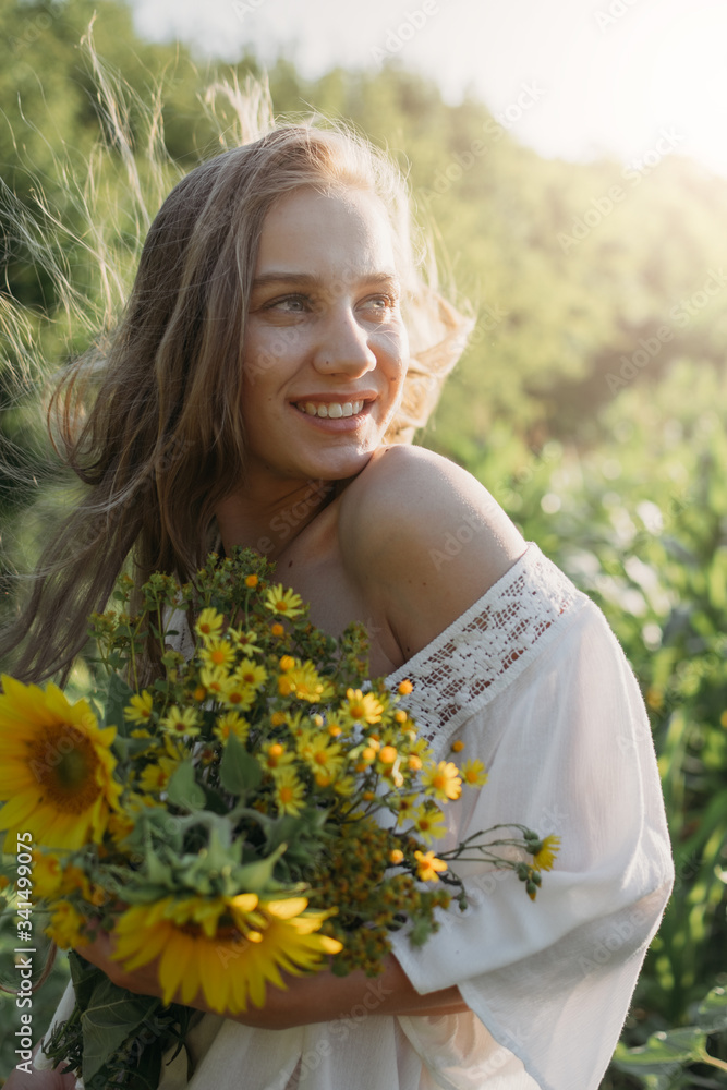 Slow living, digital detox, happiness is in small things concept. Lifestyle portrait of beautiful girl who enjoys nature and flowers in the field in sunlight Slow living, digital detox, happiness is in small things concept. Lifestyle portrait of beautiful girl who enjoys nature and flowers in the field in sunlight