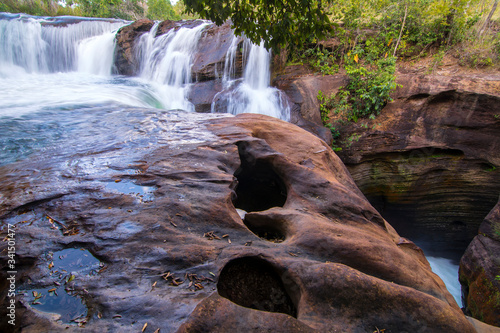 Soninho river waterfalls, in Jalapao, Brazil. Crystal clear water, blue sky. Slow shutter speed used to smooth the water. photo