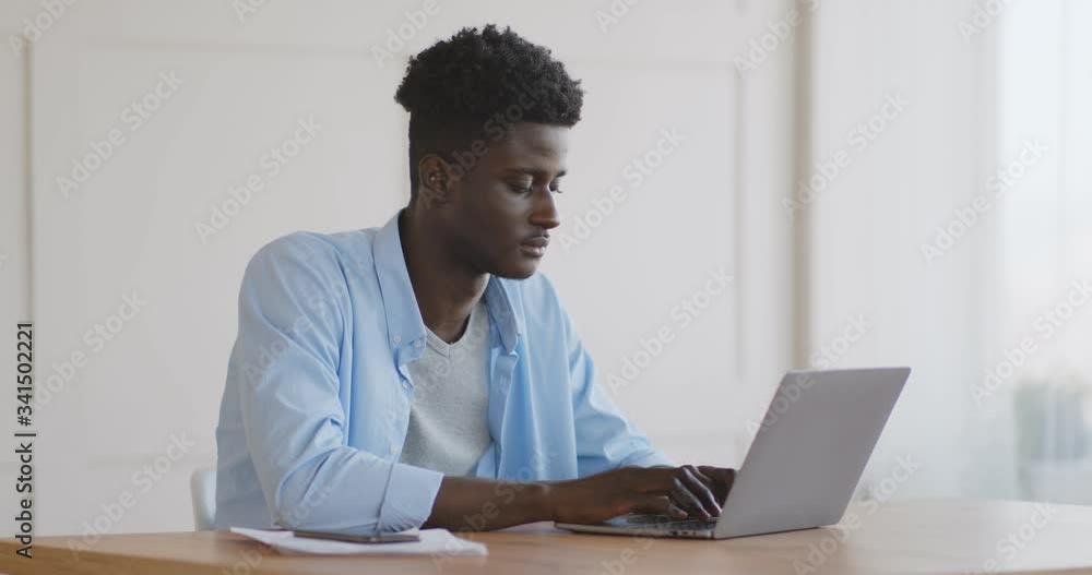 Tired african american guy yawning at workplace Tired african american guy yawning at workplace