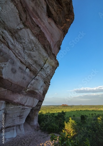 Colorful arenite rock wall, contrasting with green vegetations and blue sky in Pedra furada tourist attraction, Jalapao, Brazil.