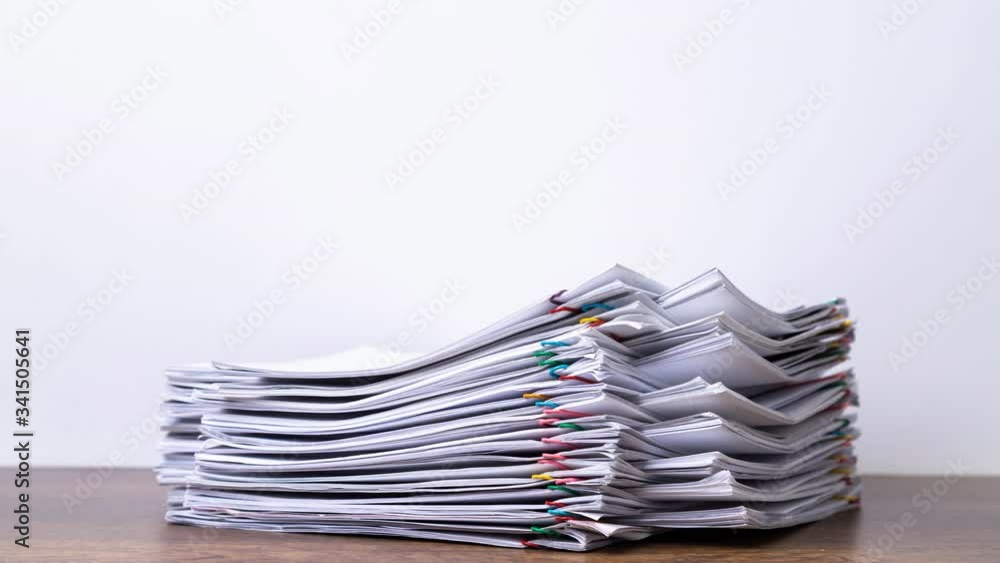 Stack overload document report paper with colorful paperclip place and copy space on black background, business concept footage paperless used – 4K Stop motion.