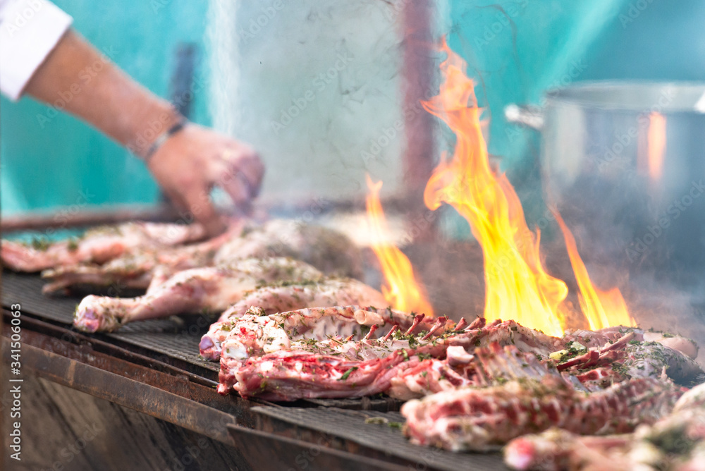 Cooking delicious meat. Italian chefs prepare treats for a large company. Large pieces of grilled meat. Cooking delicious meat. Italian chefs prepare treats for a large company. Large pieces of grilled meat.