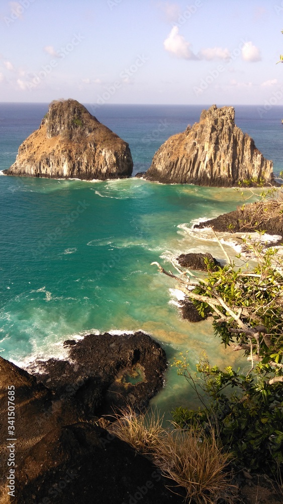 The twins (Dois irmaos), one of the main spots of Fernando de Noronha archipelago, in Brazil. Fernando de Noronha is a national park located 400km of the Brazilian coast.