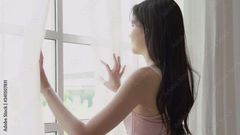 Beautiful young asian woman wake up and walking to window with open curtain in the morning with cosy, sexy girl in underwear smiling relax and resting in the vacation with happy, lifestyle concept. Beautiful young asian woman wake up and walking to window with open curtain in the morning with cosy, sexy girl in underwear smiling relax and resting in the vacation with happy, lifestyle concept.