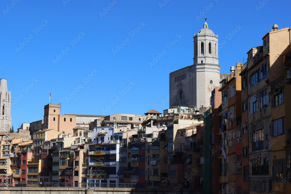 Colored houses on the river Onyar against the background of the cathedral in Girona, Catalonia, Spain