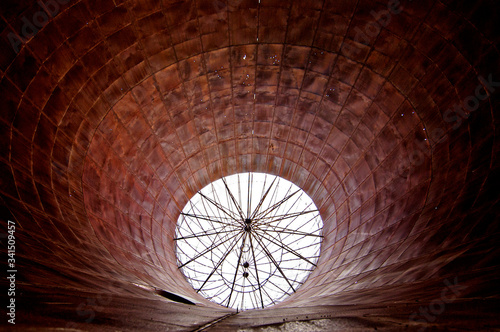 Circular abstract. Inside tee pee burner looking up at ember catching screen, Willow Ranch, California  photo