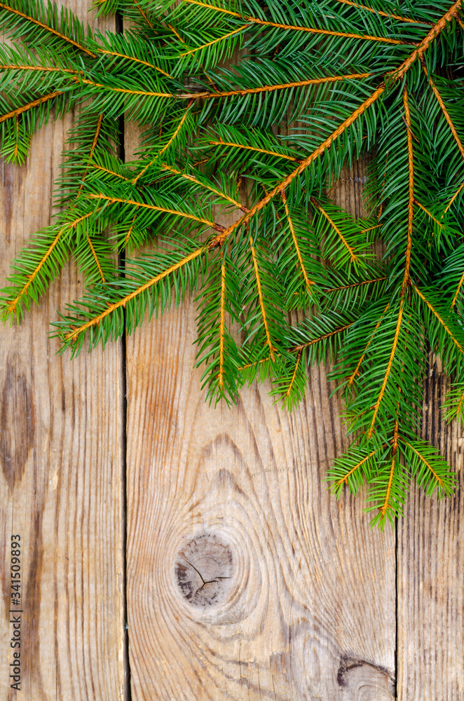 Christmas background, spruce branches on wooden surface Christmas background, spruce branches on wooden surface
