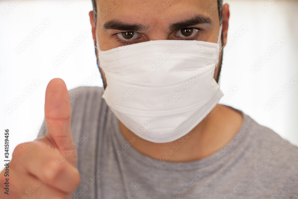 Man with a very optimistic and positive coronavirus mask with his thumb up. Man with a very optimistic and positive coronavirus mask with his thumb up.