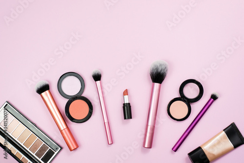 Place for text. Makeup products and decorative cosmetics on color background flat lay. Fashion and beauty blogger concept