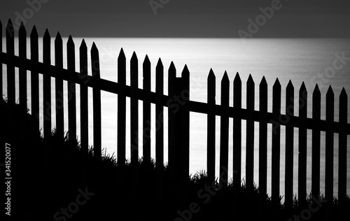Black and white photo of wooden fence 