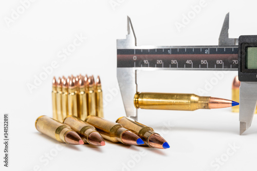 Caliper used to measure length of cartridge after seating bullet into brass during reloading or making ammunition for gun, pistol or rifle.