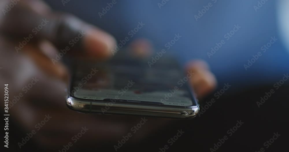 African guy scrolling social media news feed on cellphone African guy scrolling social media news feed on cellphone