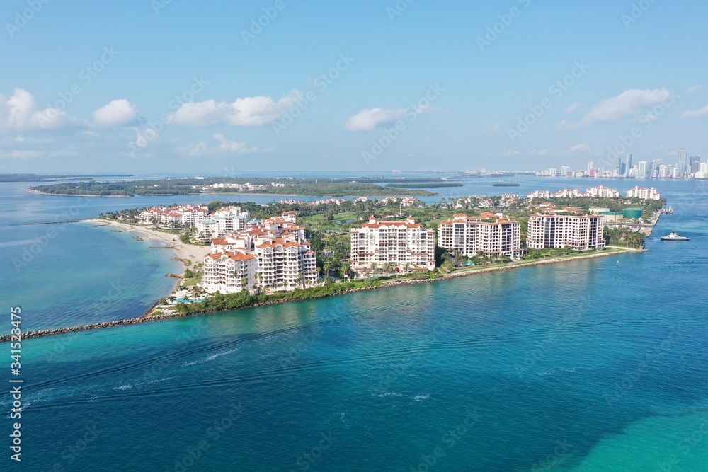 Aerial view of Fisher Island and Government Cut, Florida during COVID-19 stay-at-home order on clear sunny morning.