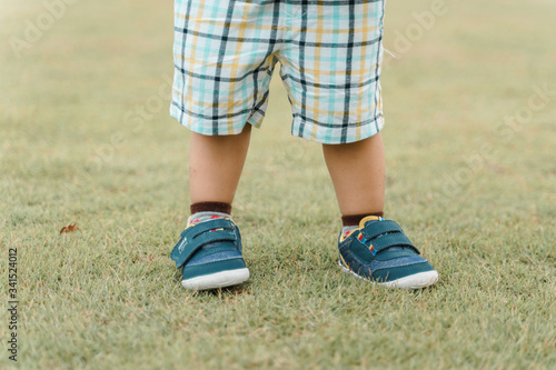 boy standing still on the grass