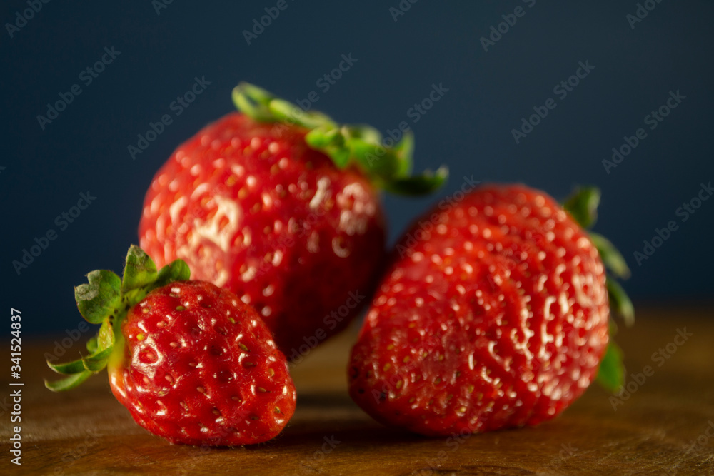 Closeup of three fresh and ripe strawberries Closeup of three fresh and ripe strawberries