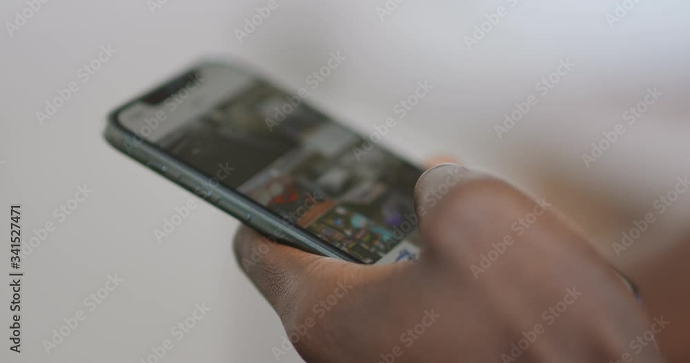 African guy networking on mobile application on cellphone, close up African guy networking on mobile application on cellphone, close up