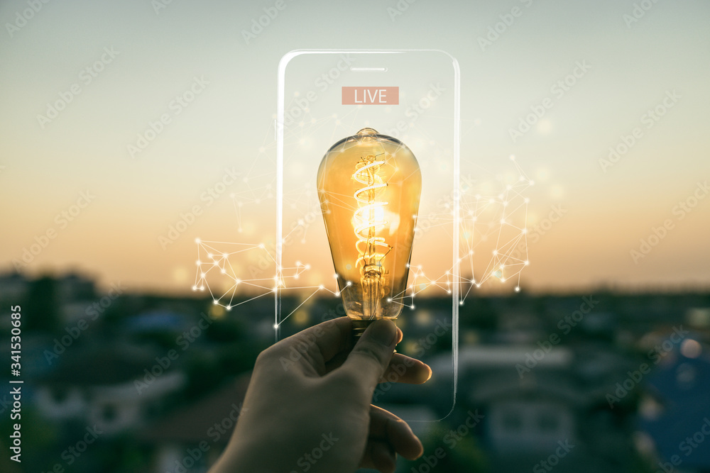 Hand business man holding light bulb with lighting frame of mobile phone and Live text. Alternative energy, idea, saving electricity innovation and inspiration concepts. - obrazy, fototapety, plakaty 