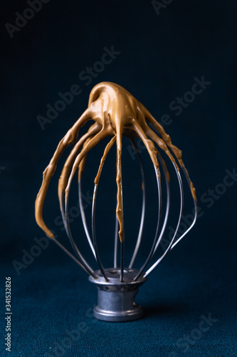 Chocolate whip on a stand mixer whip attachment with copy space