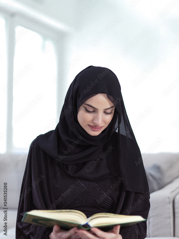 young muslim woman reading Quran at home young muslim woman reading Quran at home