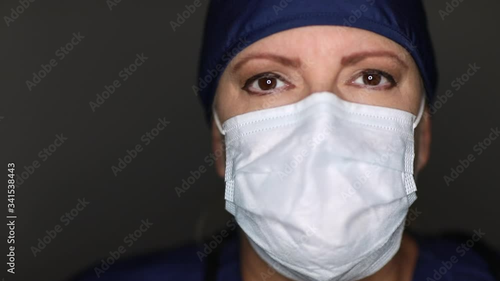 Female Doctor or Nurse Wearing Medical Face Mask Then Taking It Off of Her Face.
Female Doctor or Nurse Wearing Medical Face Mask Then Taking It Off of Her Face.