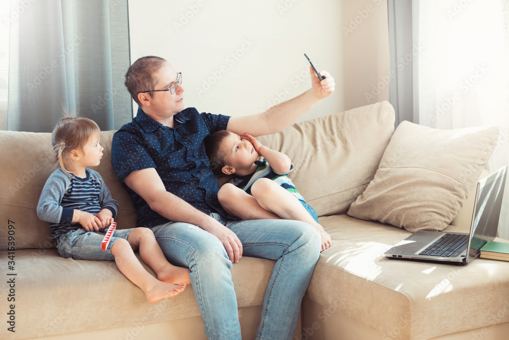 Father and his children are talking online by phone with relatives or friends. Online communication, remote communication. Father and his children are talking online by phone with relatives or friends. Online communication, remote communication.