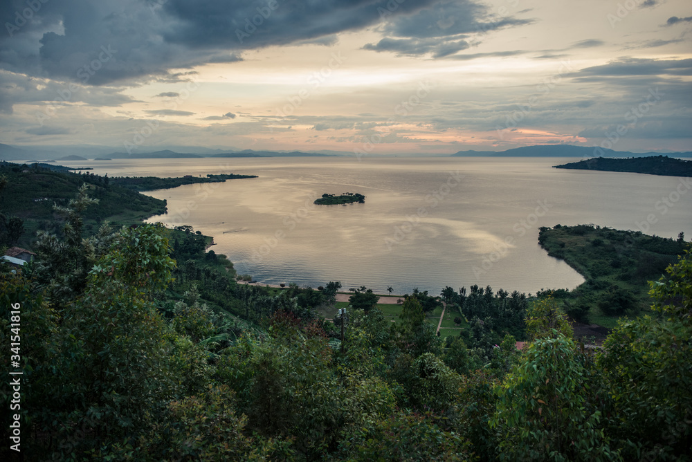 Panorama landscape of Lake Kivu during sunset, with shore among green vegetation near Kinunu