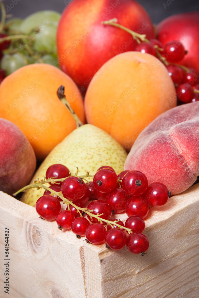 Fresh ripe fruits in wooden box. Food containing healthy minerals and vitamins Fresh ripe fruits in wooden box. Food containing healthy minerals and vitamins