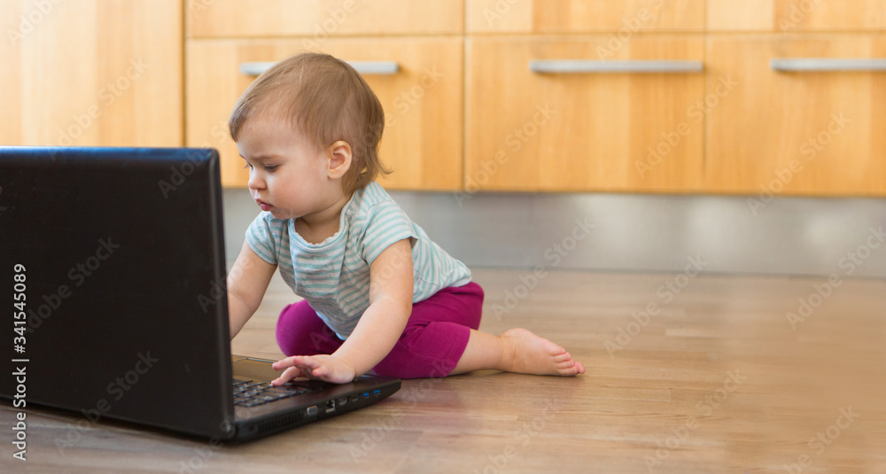 small child plays on computer. The child Prodigy learns the techniques of business Planning, home work, quarantine, self-isolation, protection from coronavirus, virus