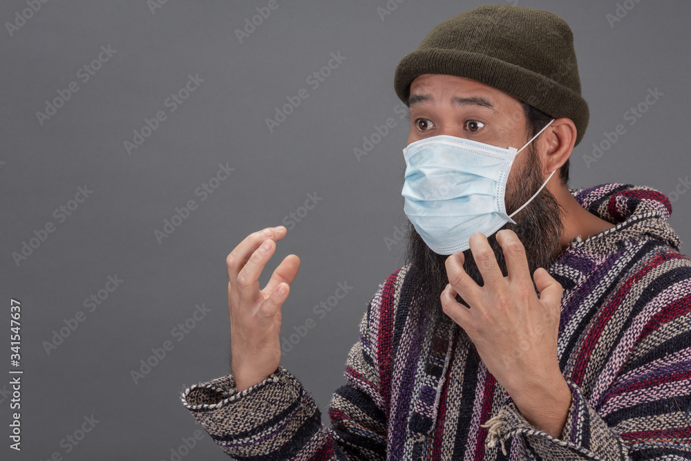 Old man surprising while wearing mask on gray background. Old man surprising while wearing mask on gray background.