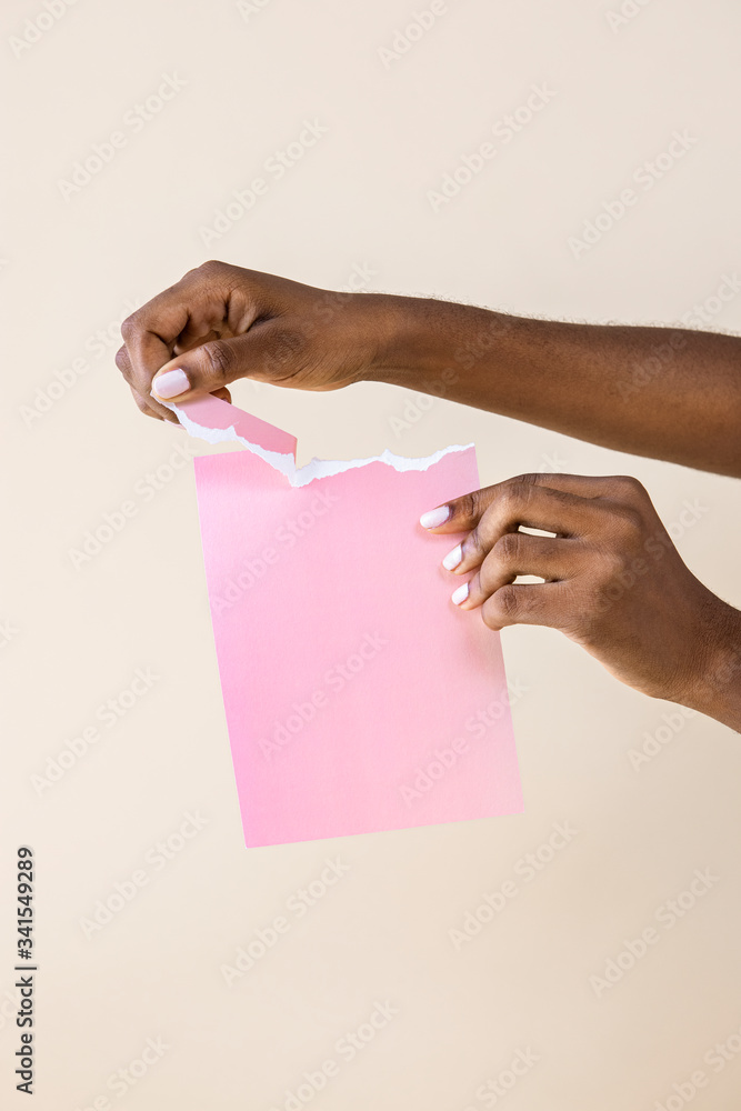 Black woman tearing pink paper Black woman tearing pink paper