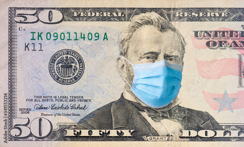 Fifty dollar bill with medical face mask on Benjamin Franklin.