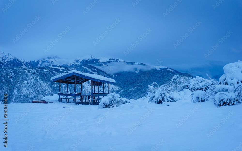 Fototapeta premium A resting shed covered with snow during evening near Talcha Airport in Mugu, Nepal.