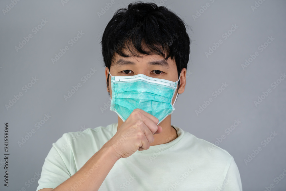 sick man wearing surgical mask (medical mask) is coughing sick man wearing surgical mask (medical mask) is coughing