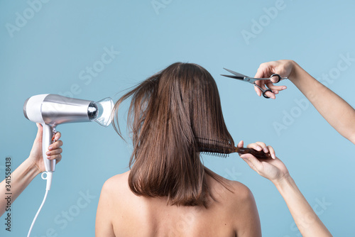 Woman getting a haircut and blow drying her hair