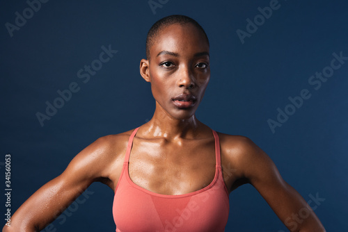 Black woman in sportswear on navy blue background