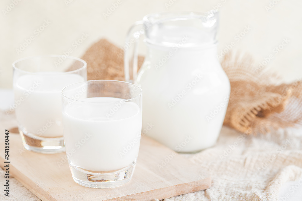 Milk.Milk bottle and milk glass on wooden table.Glass jug and glass with milk.Healthy eating concept Milk.Milk bottle and milk glass on wooden table.Glass jug and glass with milk.Healthy eating concept
