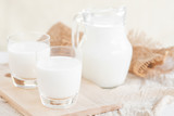 Milk.Milk bottle and milk glass on wooden table.Glass jug and glass with milk.Healthy eating concept