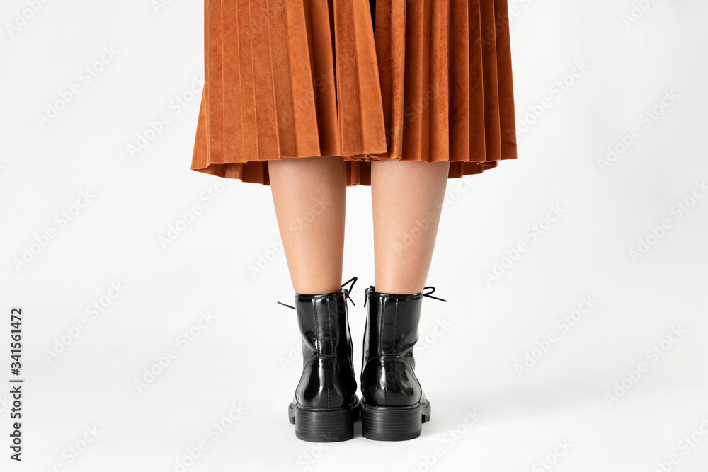 Woman in a skirt wearing combat boots Woman in a skirt wearing combat boots