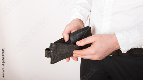 Bankruptcy - Business Person holding an empty wallet. Man showing the inconsistency and lack of money and not able to pay the loan and the mortgage.