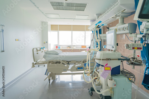 Empty adjustable patient's bed in hospital room for medical treatment and rehabilitation.