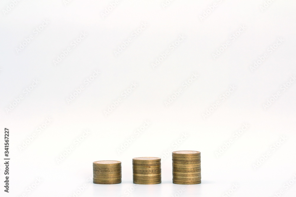 Piles of golden metallic coins. Columns of coins of different heights. The concept of business, economy, finance, investment and prices. Place for text and background for design. Piles of golden metallic coins. Columns of coins of different heights. The concept of business, economy, finance, investment and prices. Place for text and background for design.