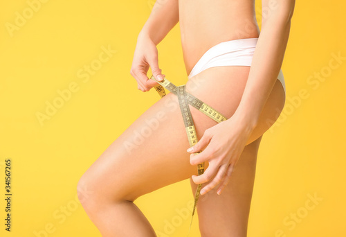 Young woman with measuring ...