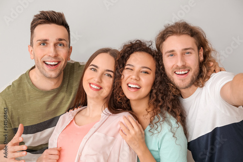 Friends taking selfie on gr...