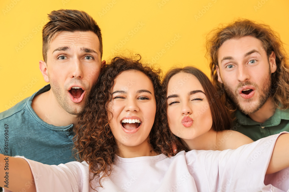 Friends taking selfie on color background Friends taking selfie on color background