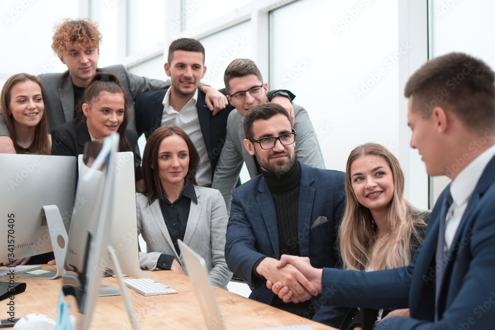 business partners shaking hands at the office Desk