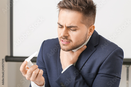 Ill young man with inhaler ...