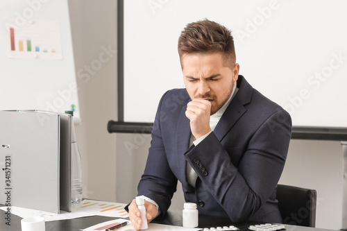 Ill young man in office